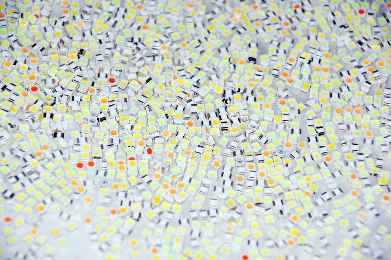 Densely packed SMD LEDs with yellow, green and orange phosphor-converted emitting surfaces.